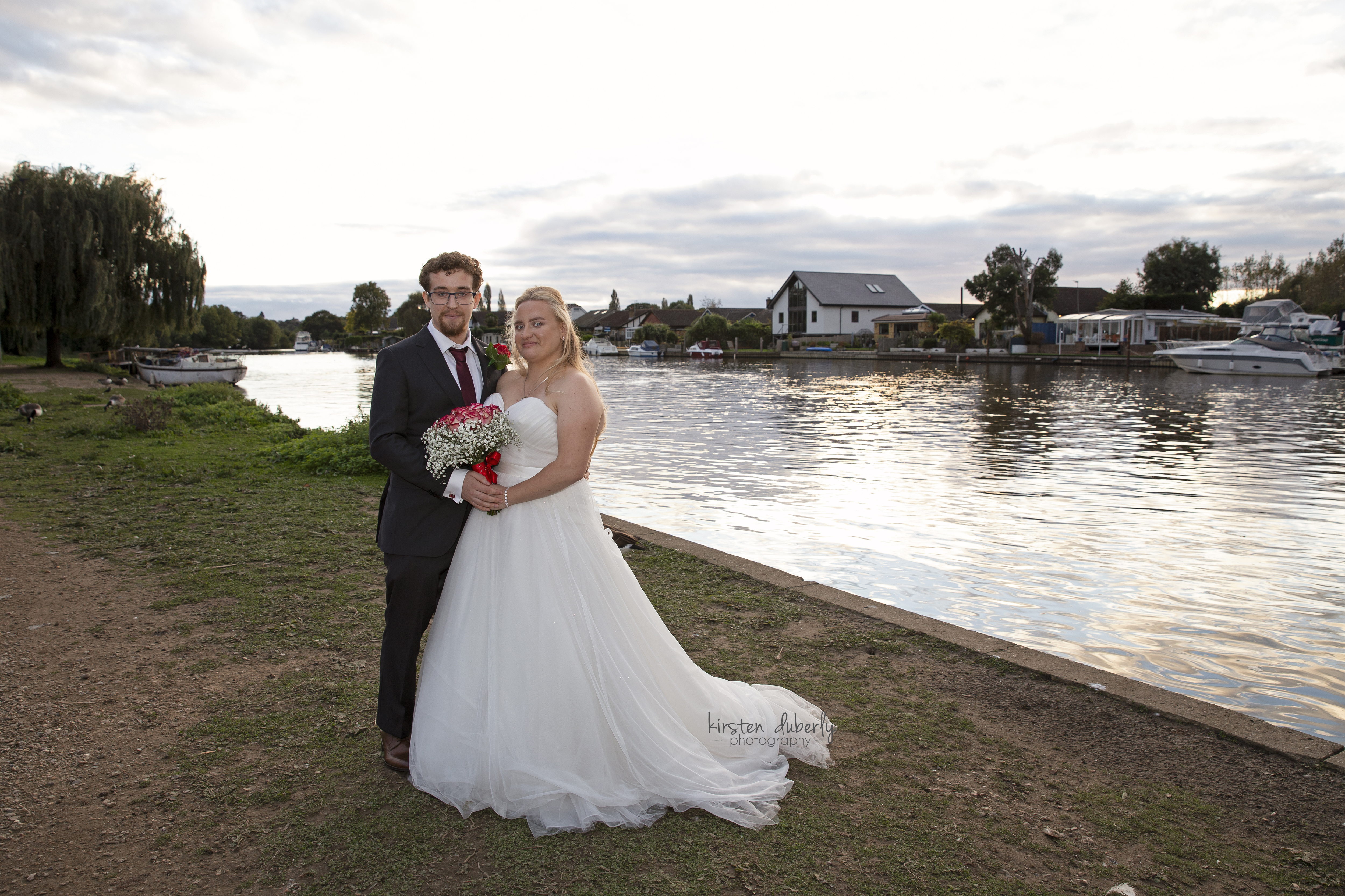 Wedding couple near Weybridge River. Copyright Kirsten Duberly Photography